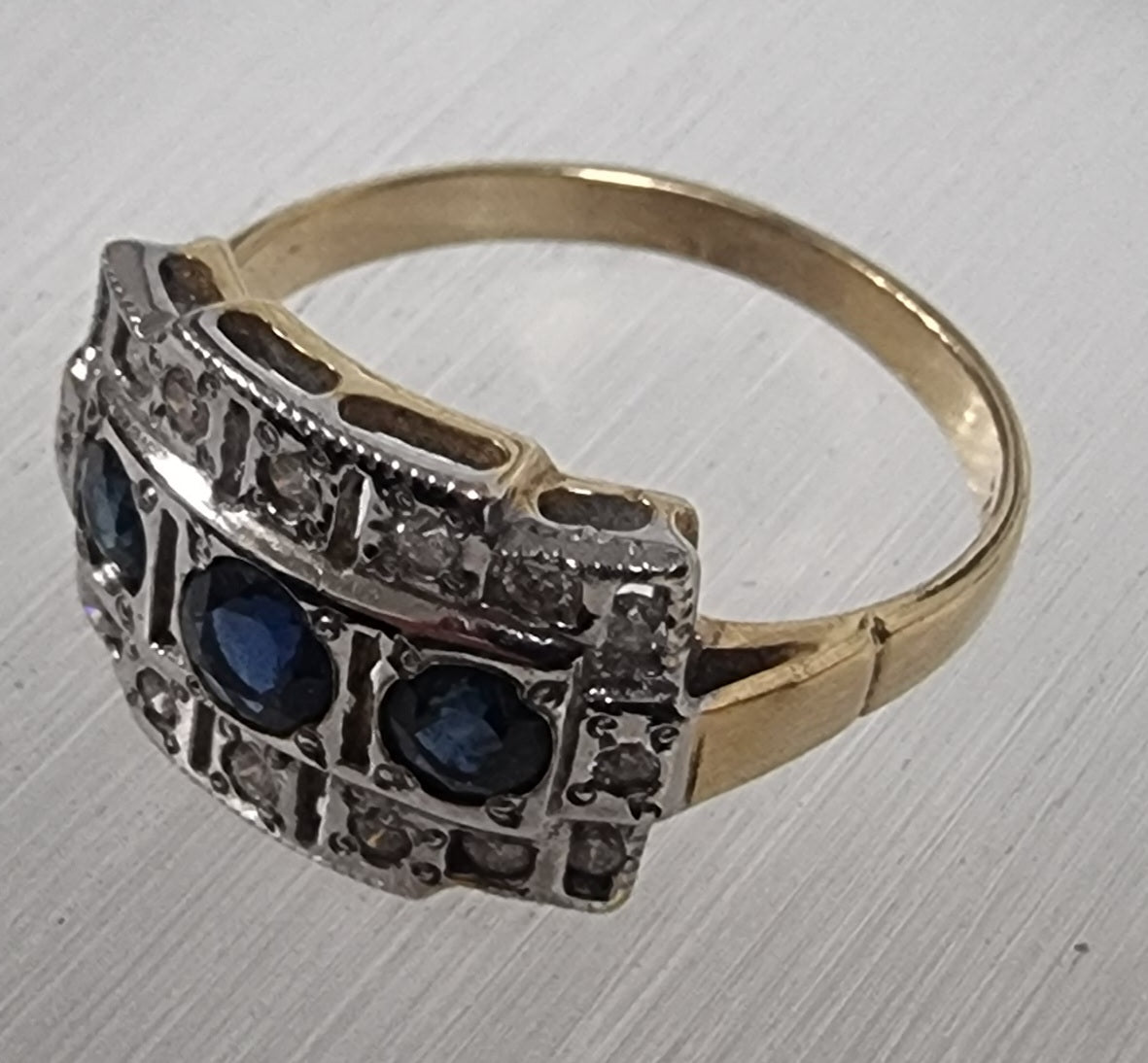 Blue sapphire with diamond ring set in white and yellow gold